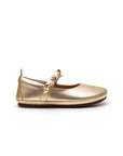 Side view of the metal gold Brigitte kids shoe showing the low profile and flat, ergonomic sole design.