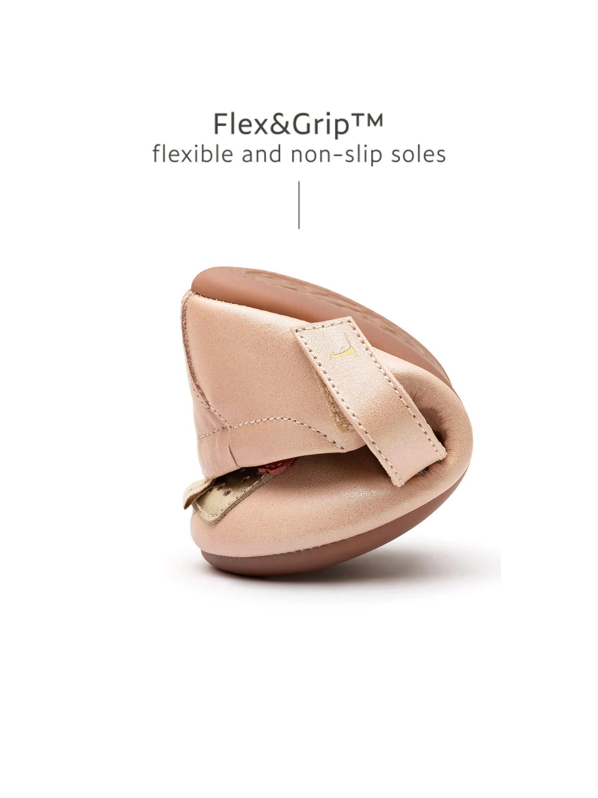 A pink baby shoe folded in half to show the Flex&amp;Grip ultra-flexible, non-slip sole.