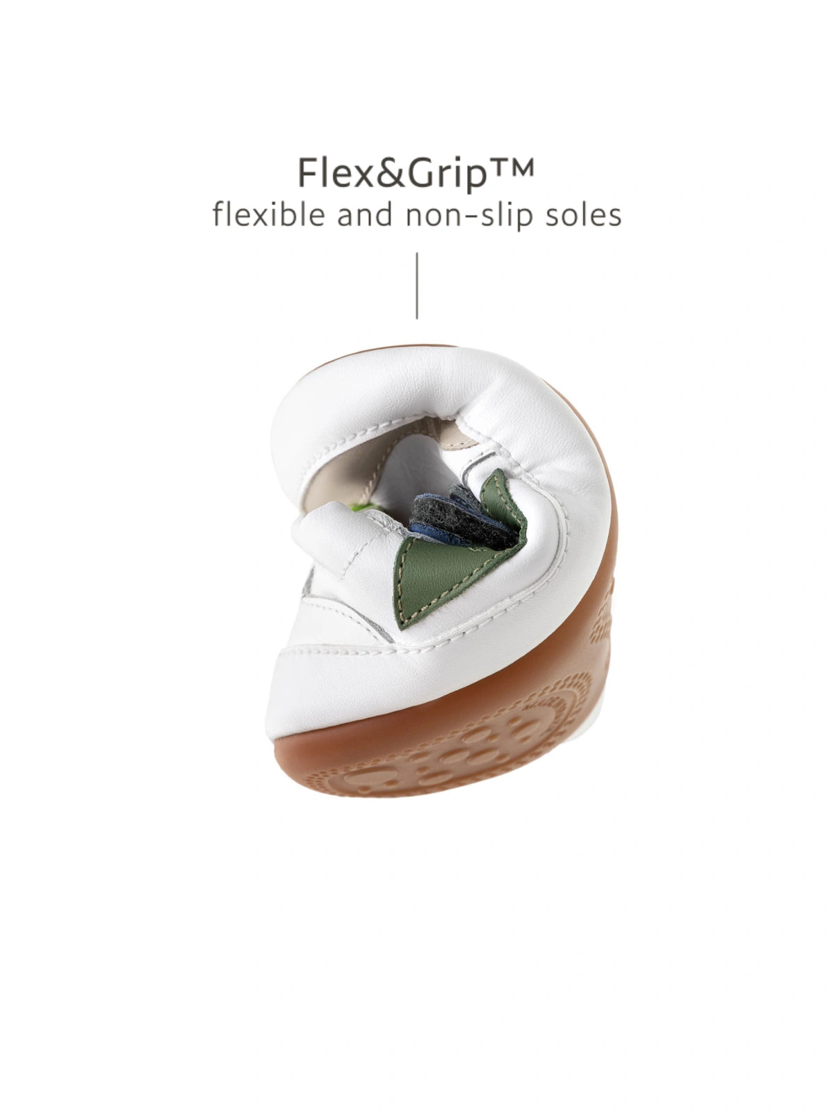 Demonstrating the flexible FlexiGrip sole on the white and navy baby sneaker, designed for natural foot movement.
