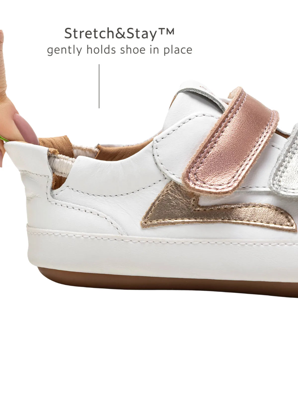 Close-up of the Stretch &amp; Stay elastic heel and rose gold accent on the Landy baby sneaker for easy dressing.