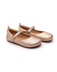 Pair of metallic salmon pink leather Marie ballet flats for kids with a flexible rubber sole and secure strap.