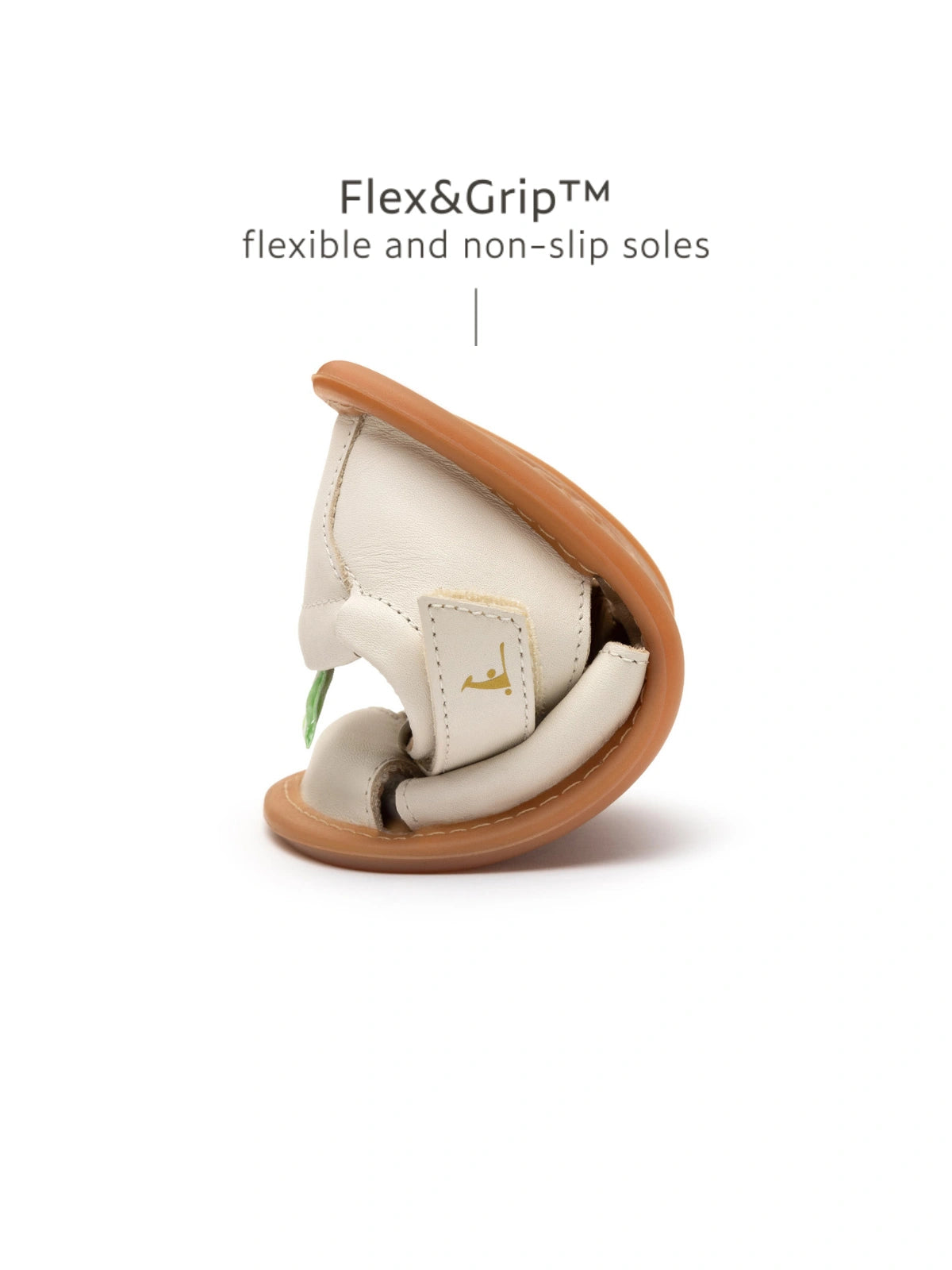 Demonstrating the flexible FlexiGrip rubber sole on the Tapioca leather baby sandal for natural foot movement.