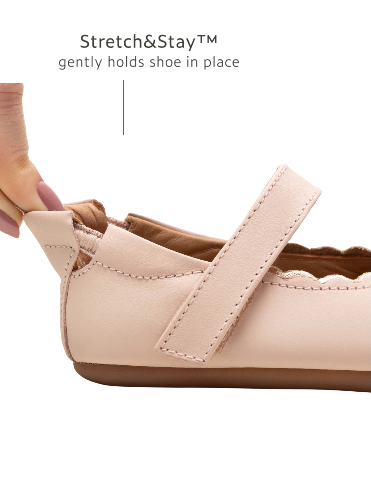 Close-up of the Stretch &amp; Stay elastic heel on the pink baby shoe, ensuring a snug fit that stays on.