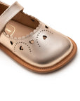 Close-up of the premium metallic salmon leather and intricate heart-shaped cut-outs on the baby Mary Jane toe.
