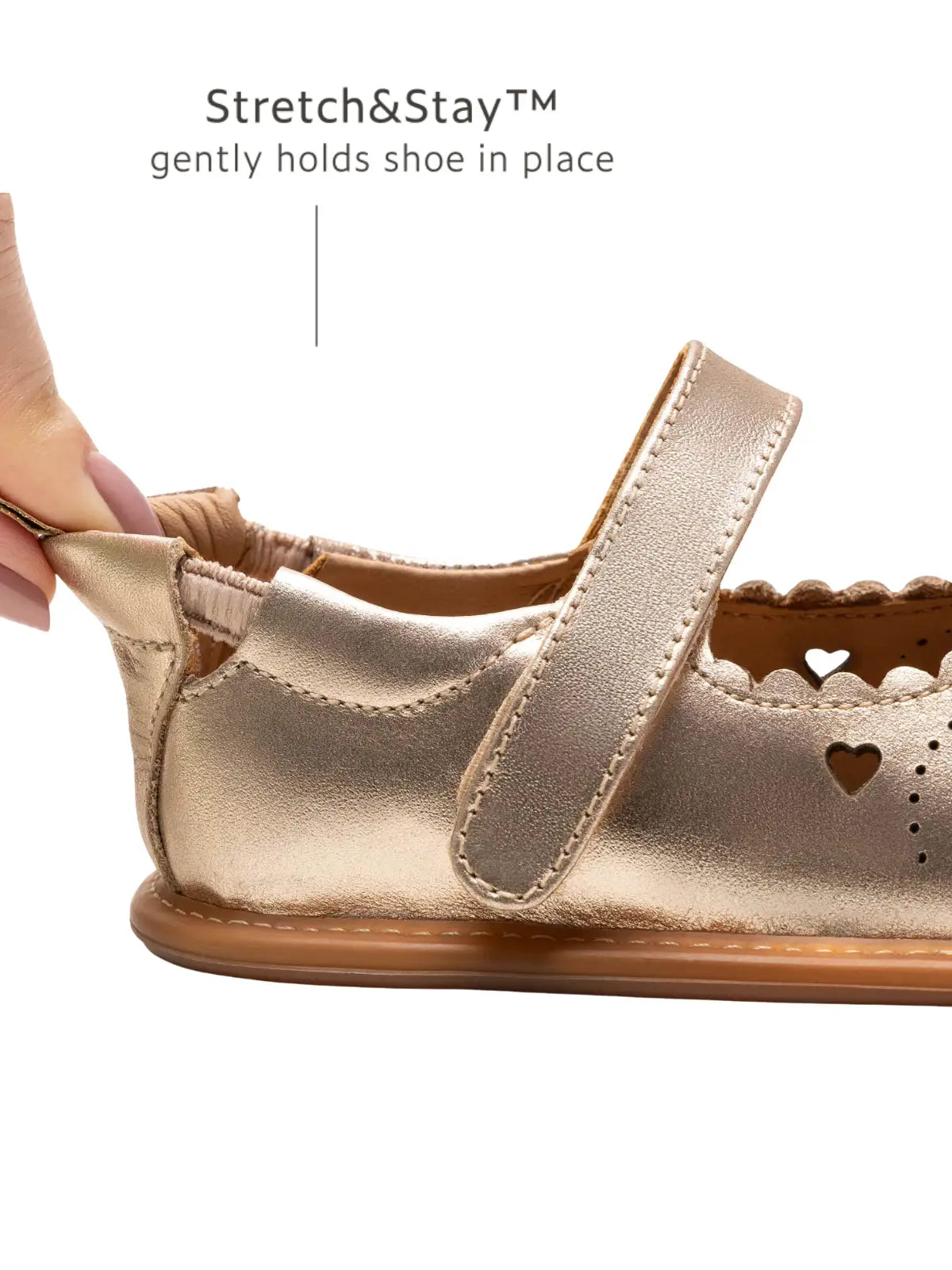 Close-up of the Stretch &amp; Stay elastic heel on the metallic salmon baby shoe for a secure and comfortable fit.