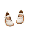 Angled view of Tapioca baby shoes showing the soft leather finish and decorative heart toe detail.