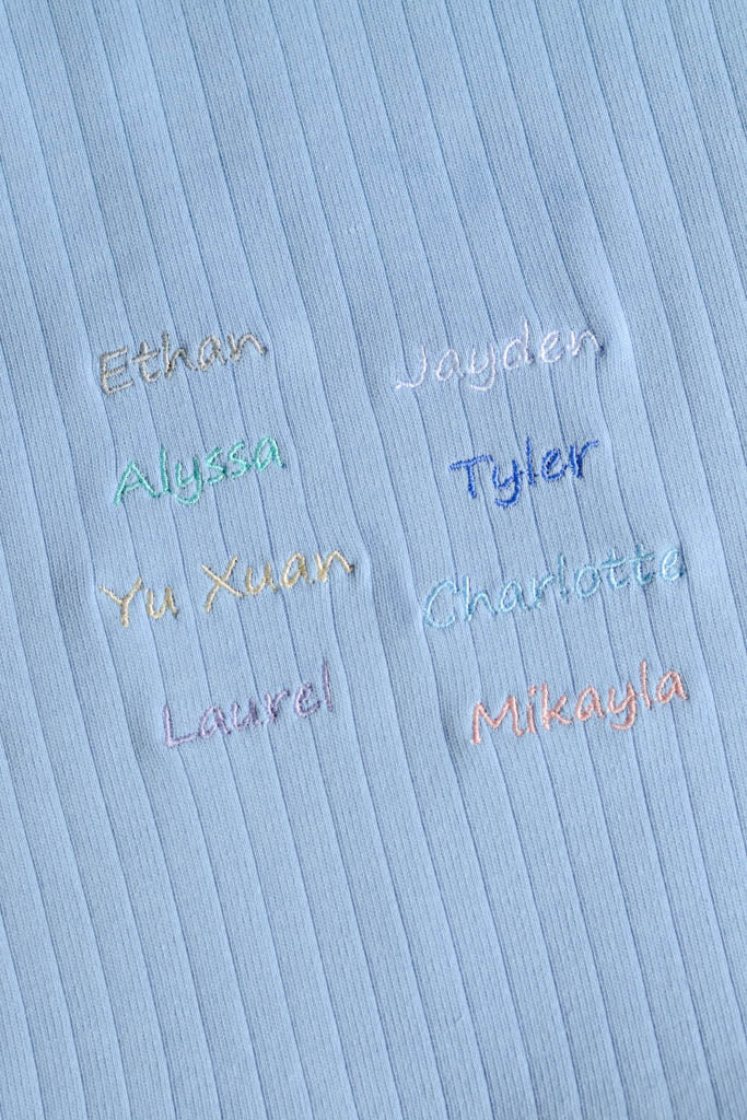 embroidered names on blue fabric