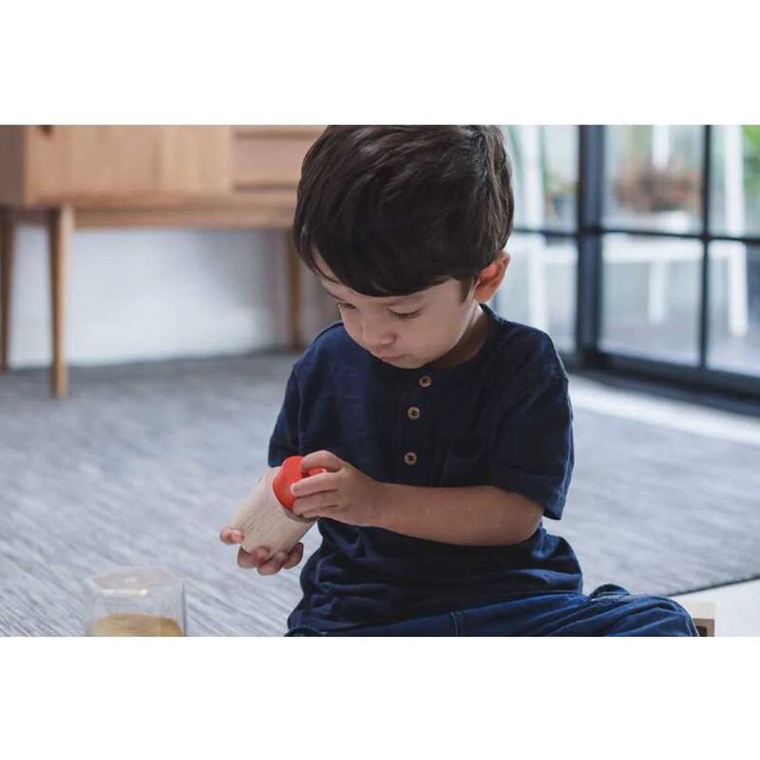 Child playing with PlanToys Geo Matching Blocks